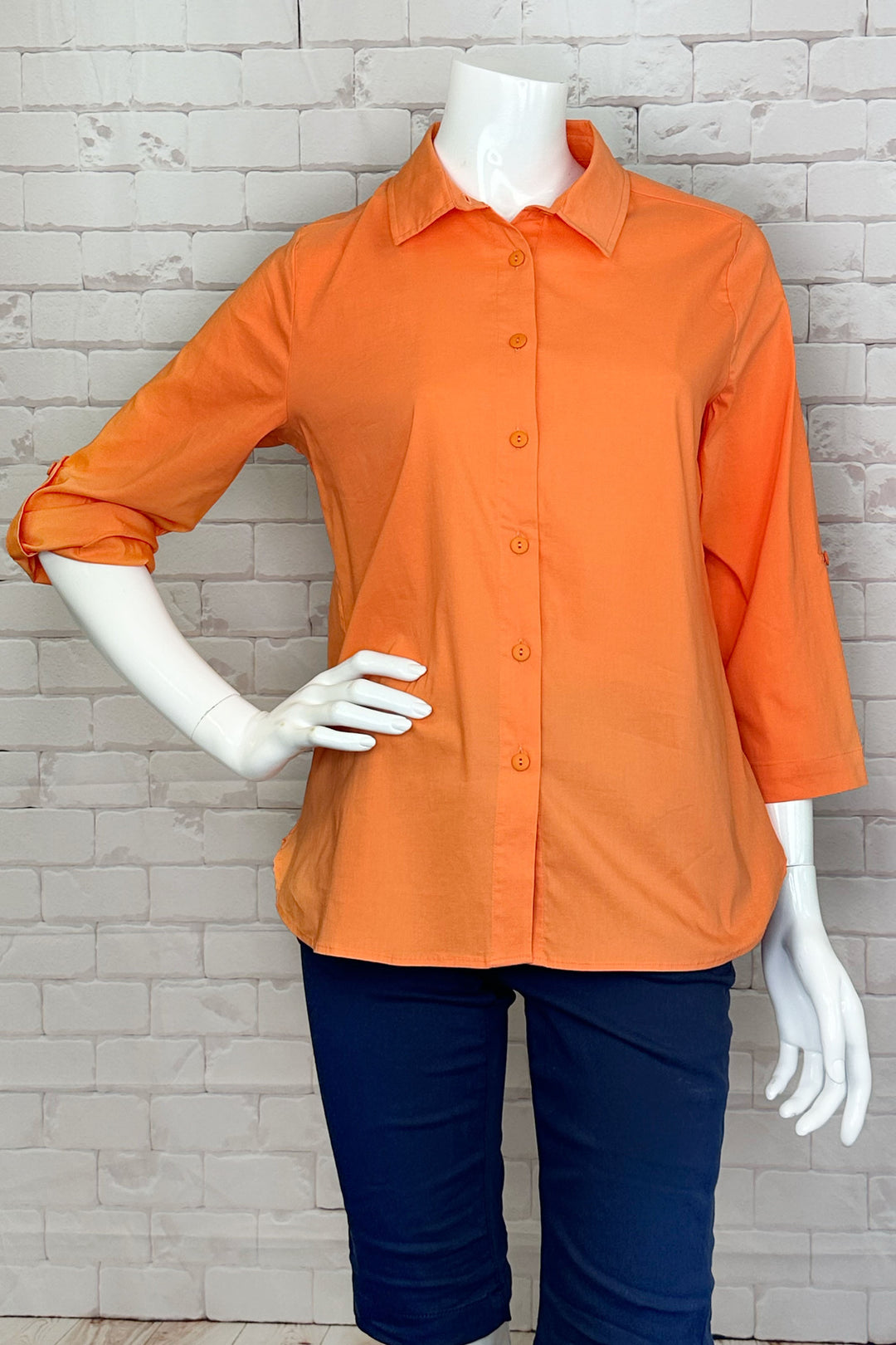 Dolcezza Spring 2024 This 3/4 length sleeve blouse features a classic style, cotton-blend fabric, solid spring and summer colours and full front buttons.