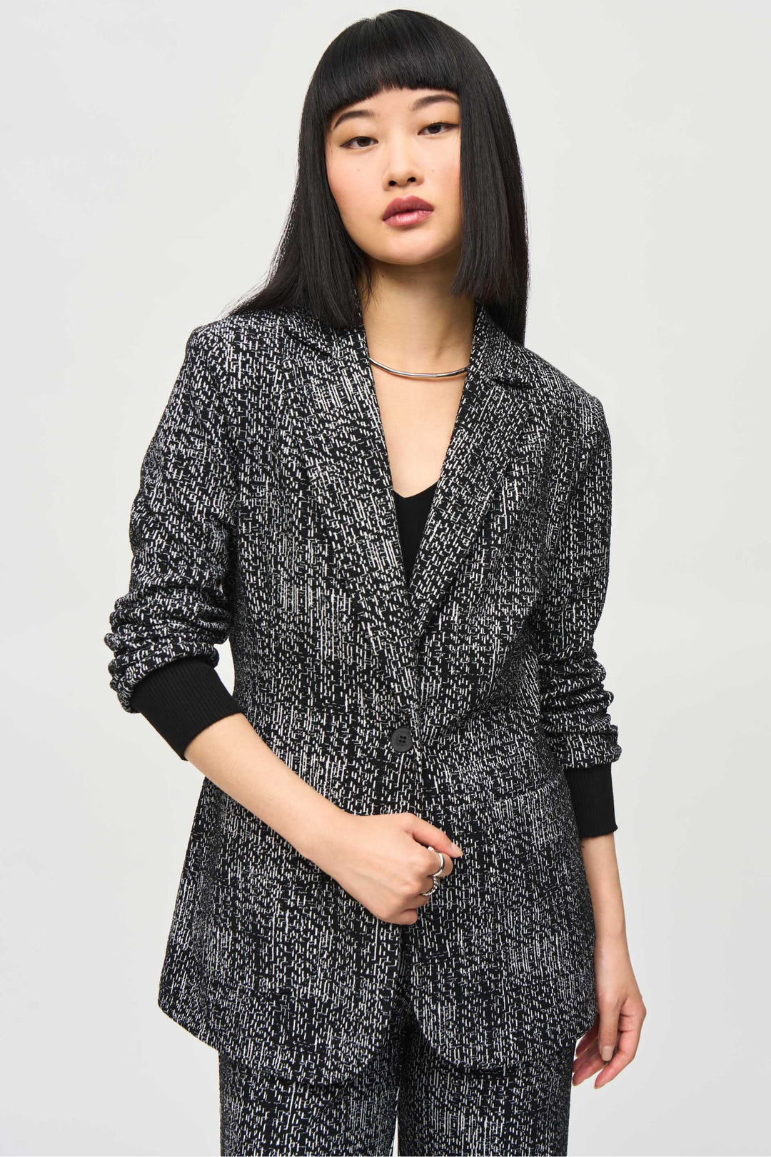 Joseph Ribkoff Fall 2024 Crafted from a luxurious tweed knit fabric, this blazer features a single button closure and a classic notch collar. The thin and lightweight design is perfect for any occasion, while the 3/4 length sleeves add a touch of elegance.