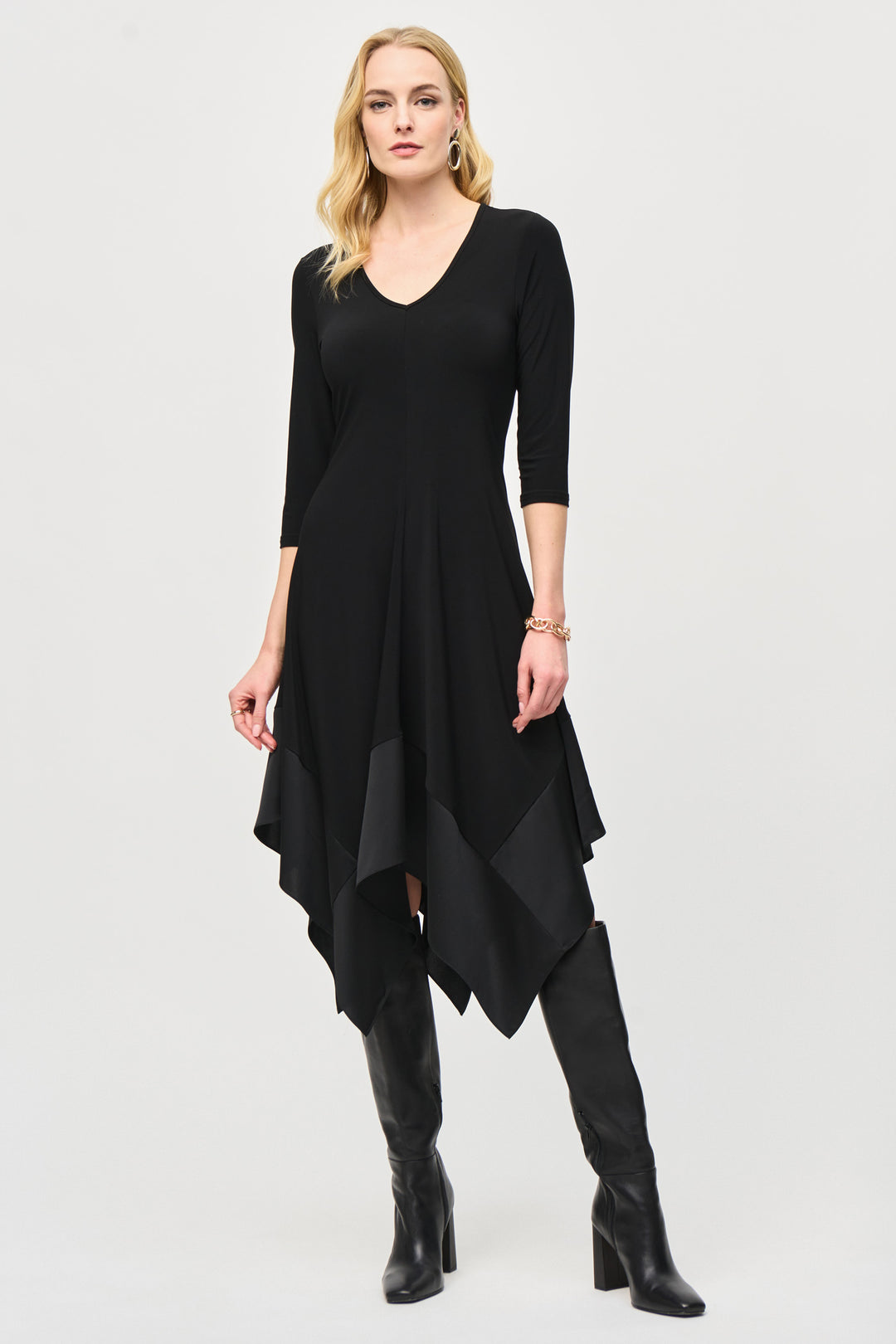 Joseph Ribkoff Fall 2024 The open neck style and 3/4 sleeves add a touch of elegance. The lovely handkerchief hem completes the ensemble for a chic and memorable outfit.