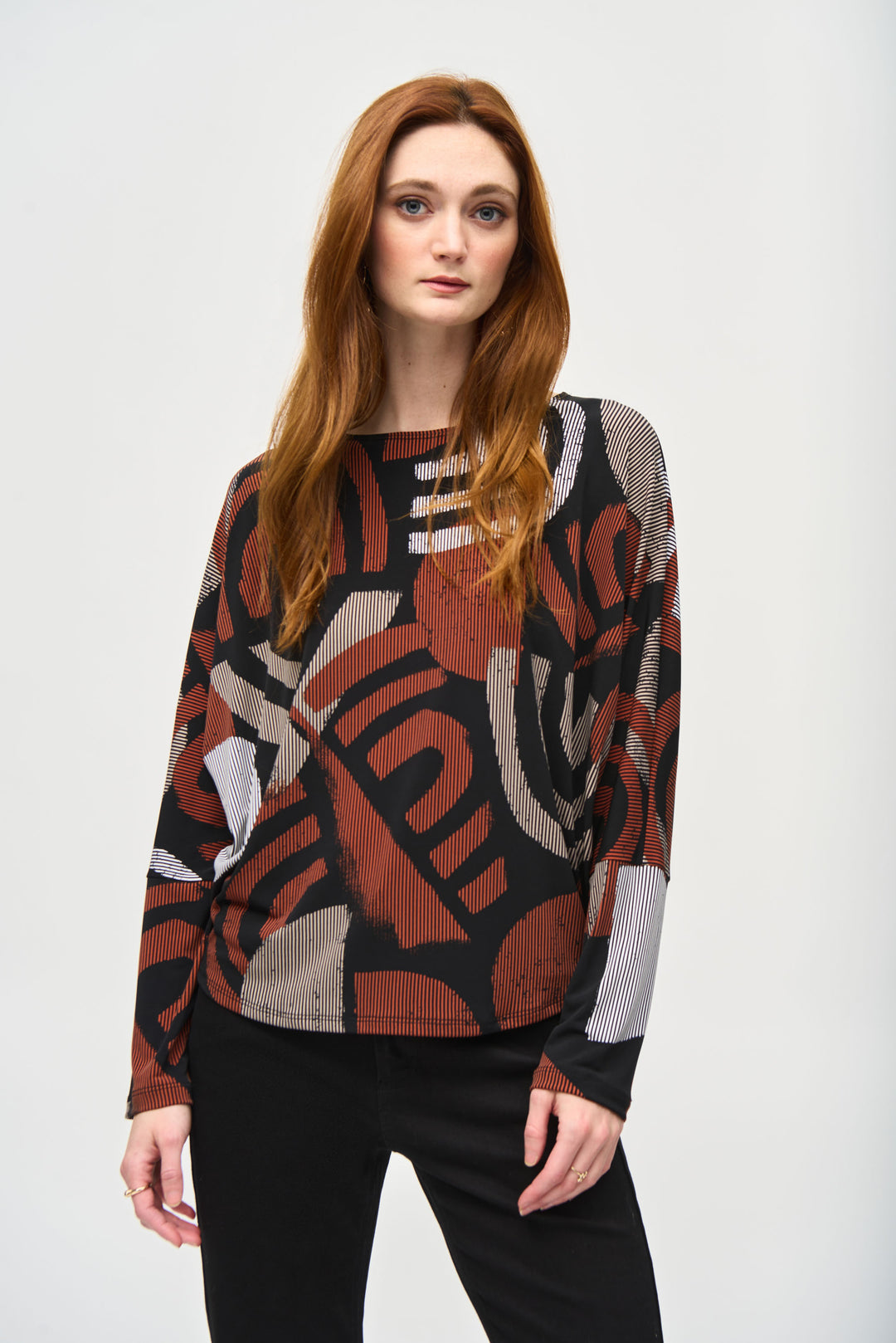 Joseph Ribkoff Fall 2024 Featuring a boat neck style and full length dolman sleeves, this top is made with silky like fabric for an irresistibly comfortable feel!