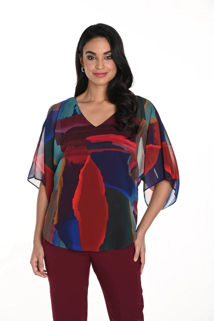 Frank Lyman Fall 2024  Its bright and rich colours paired with the vibrant almost poncho style, will make you stand out in any crowd! 