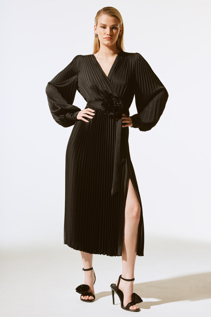 Joseph Ribkoff Fall 2024  The free-flowing wrap v-neck style effortlessly drapes your figure, while the pleated chiffon fabric adds a touch of elegance. 