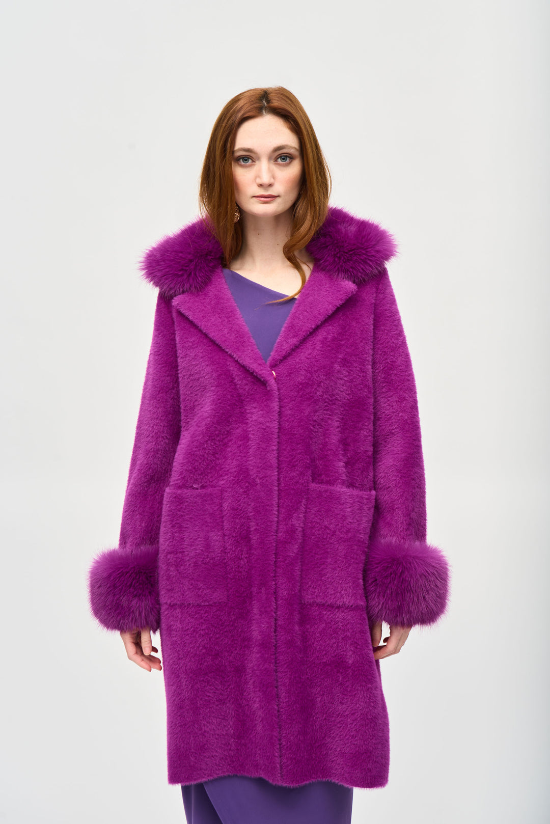 Joseph Ribkoff Fall 2024 Made with soft feather yarn and a warm faux fur hood, this sweater knit coat also features convenient side pockets.