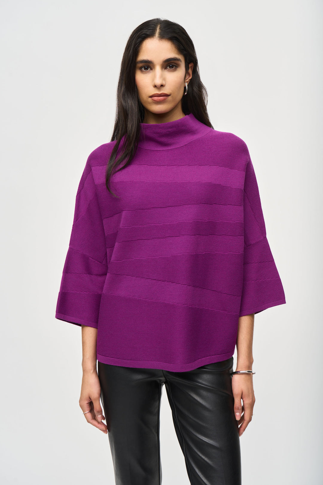 Joseph Ribkoff Fall 2024 This relaxed fit sweater top features a neat mock neck, 3/4 length sleeves, and stitch details, creating a boxy and effortlessly chic look.