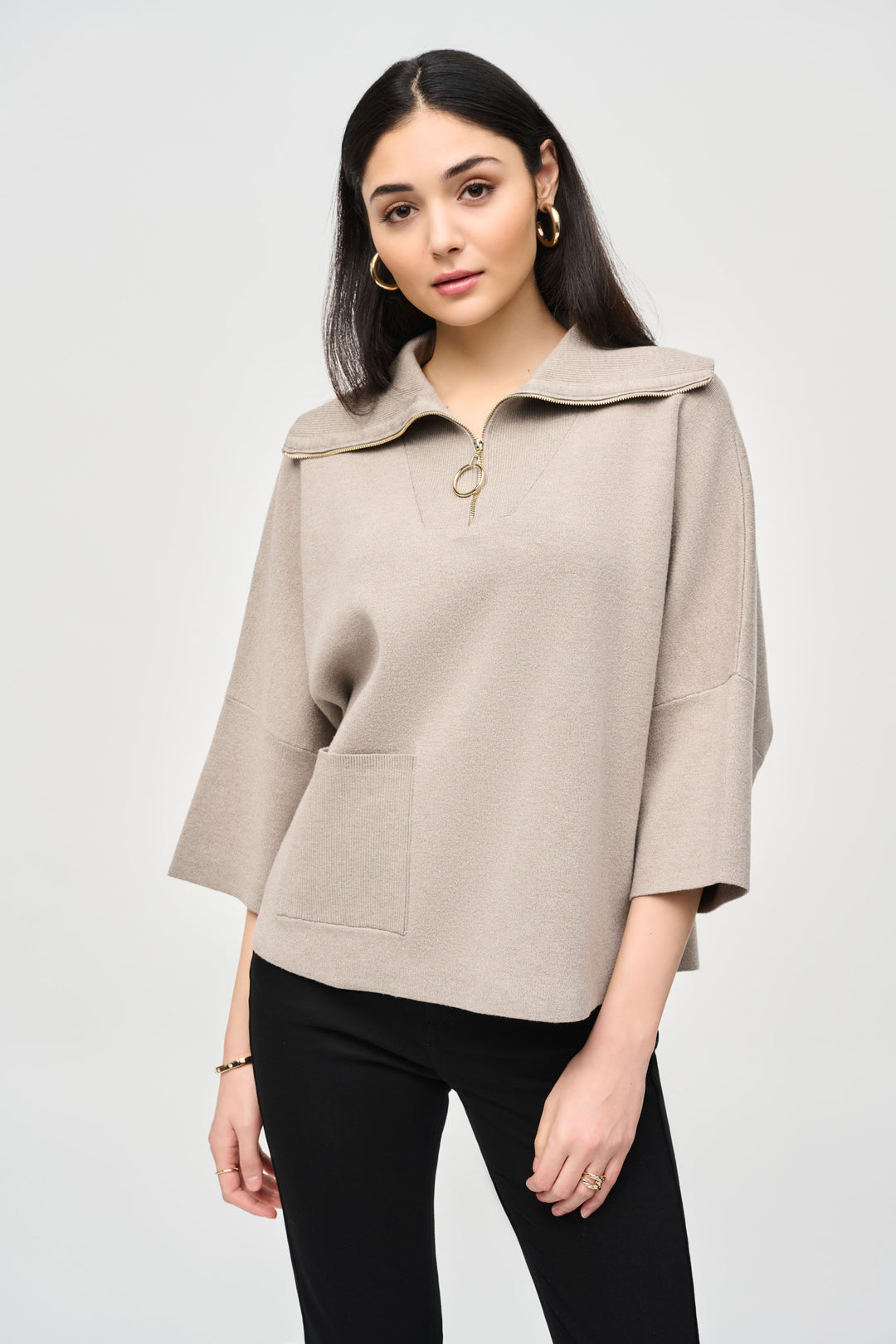 Joseph Ribkoff Fall 2024 With a boxy cut and elegant knit patch pocket, this sweater top is perfect for any occasion. The zip collar and 3/4 length sleeves add a touch of sophistication, while still being casual enough for everyday wear.