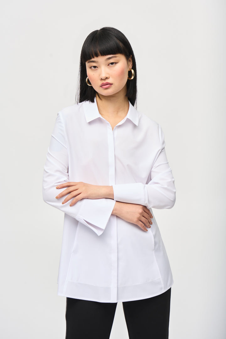 Joseph Ribkoff Fall 2024 Featuring a classic collar, slit cuff details and front pockets, this blouse exudes sophistication. Wear it untucked with dress pants or slim fit jeans for a versatile and stylish look this season