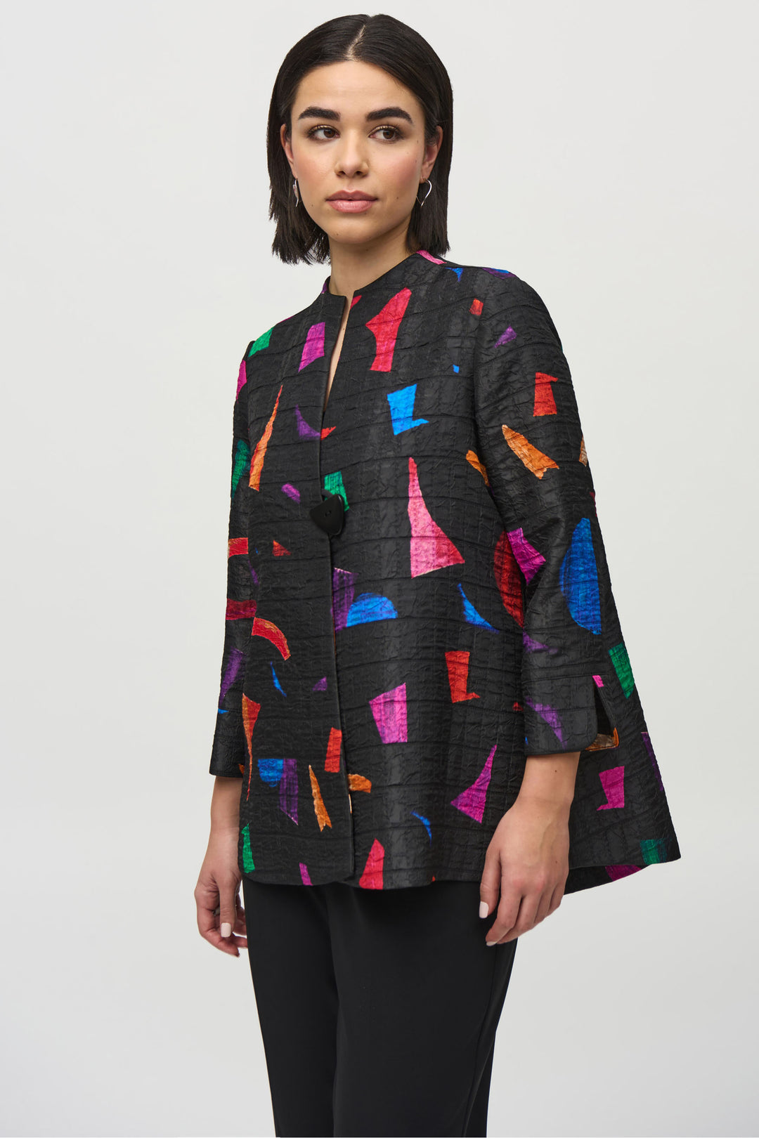 Joseph Ribkoff Fall 2024 Crafted with 3/4 cuffed sleeves and a single button with a mandarin collar, this stunning trapeze jacket boasts an abstract print to create volume and dimension overall.