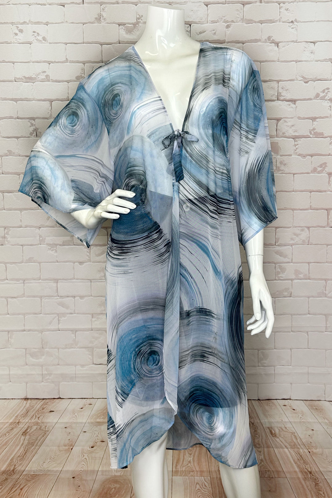 Dolcezza Spring 2024 With its lovely tie knot front, loose drape half sleeves and high low hem, this cover up beachwear is perfect for a relaxed and stylish look. 