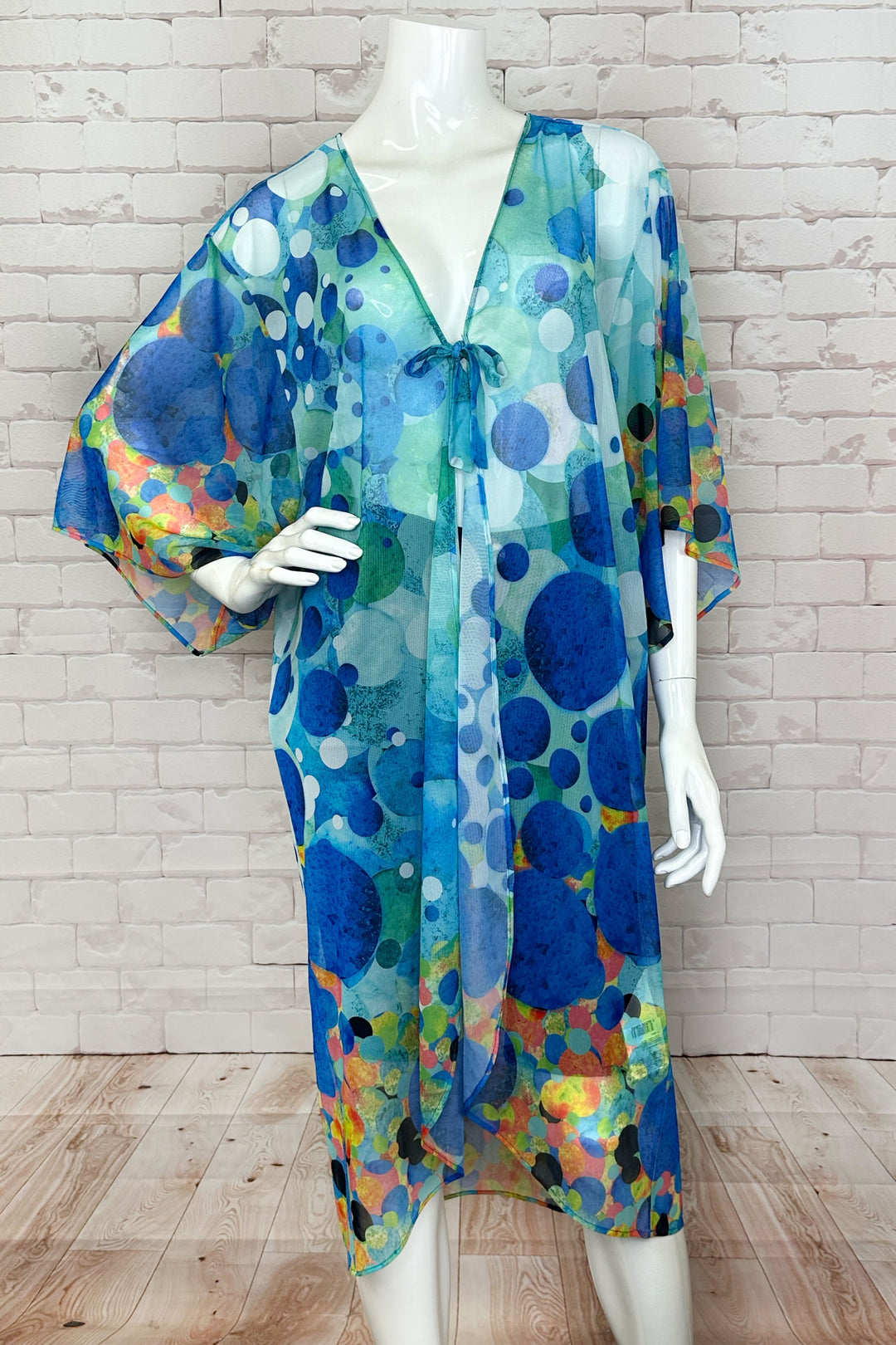 Dolcezza Spring 2024 With its lovely tie knot front, loose drape half sleeves and high low hem, this cover up beachwear is perfect for a relaxed and stylish look