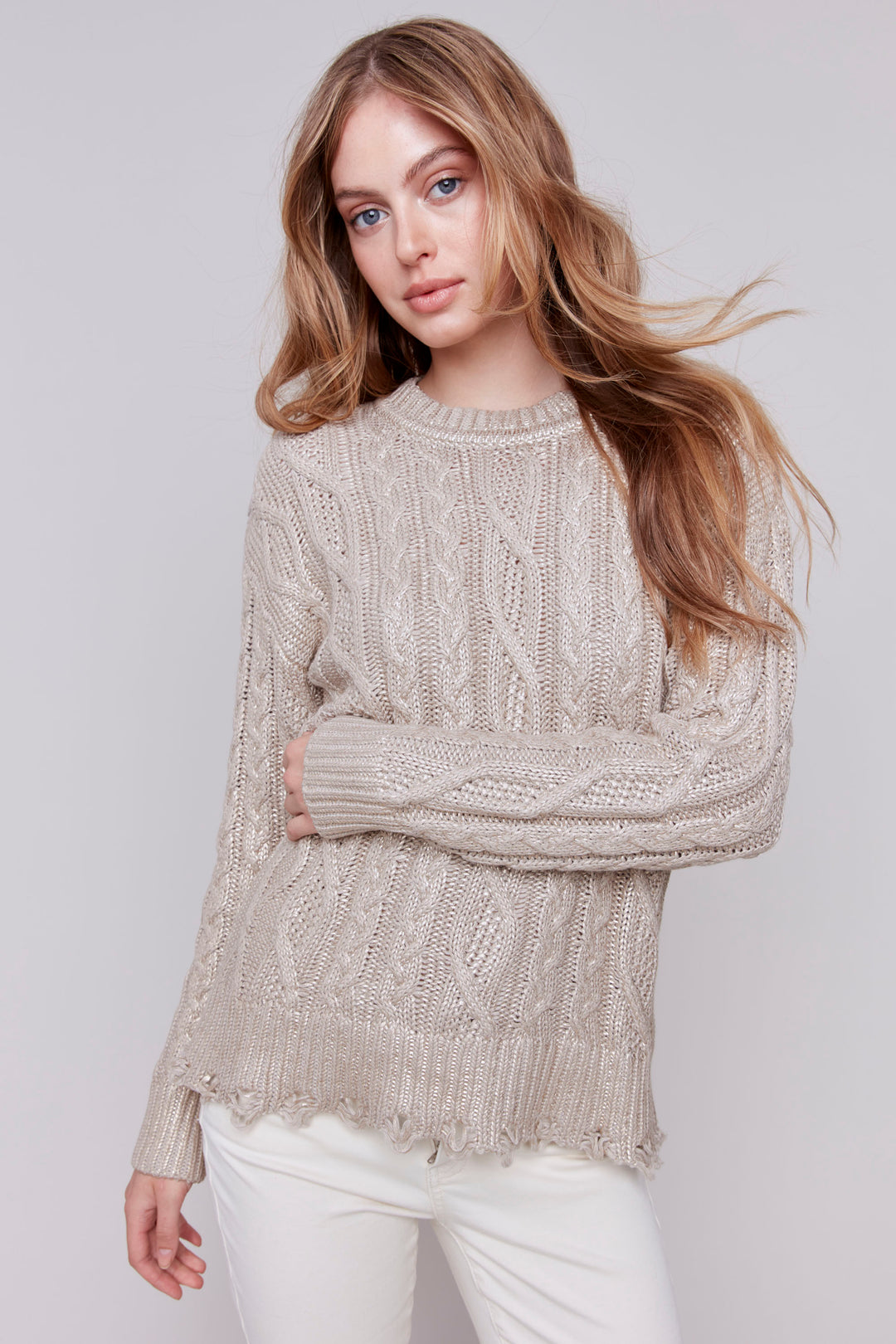 Charlie B Fall 2024 The slight fringe hem adds a touch of texture, while the full length sleeves and round neckline provide comfort and versatility. With a stunning foiled design finish, this top will elevate any outfit this fall.