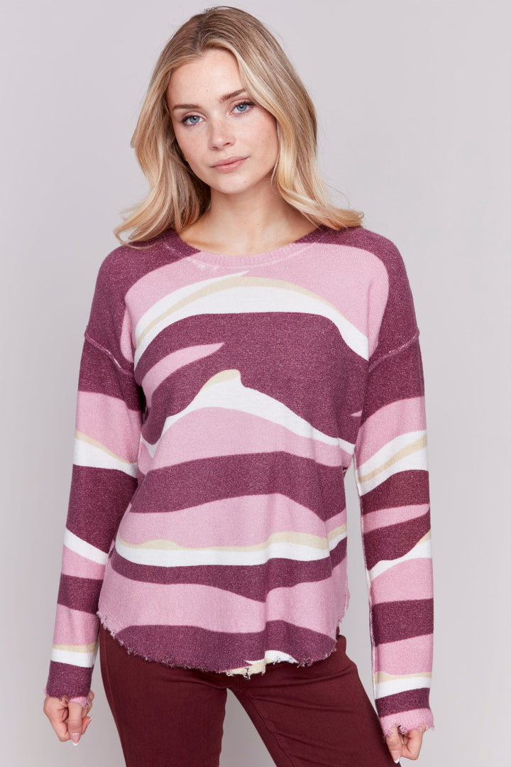 Charlie B Fall 2024 Experience the beauty of earth's vibrant colours in the Reversible Wavy Stripe Top. Featuring a reversible round neck sweater printed with a stunning, colorful long wavy stripe pattern, this versatile top is perfect for brightening up any closet!