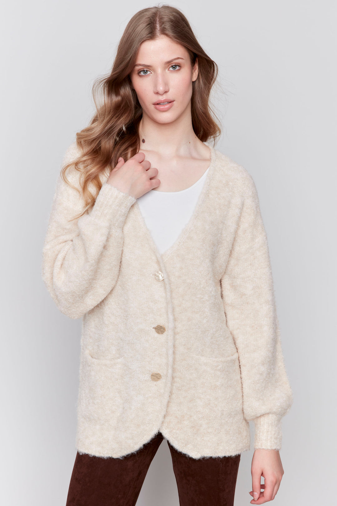 Charlie B Fall 2024  Featuring a boucle knit design, this long cardigan offers a cozy fit and a light, soft texture. The front buttons allow for easy wear and it can be styled in multiple ways. 