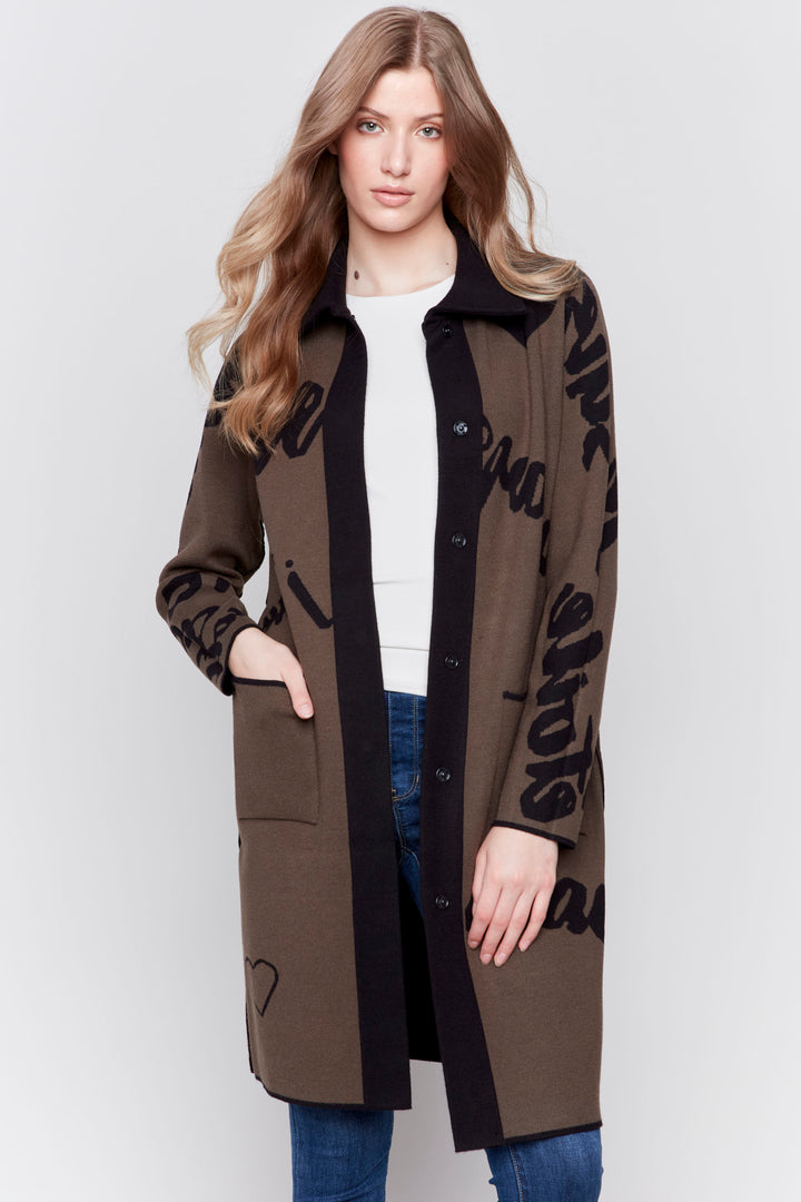 Charlie B Fall 2024 Featuring a cool words print design, this jacquard knit long cardigan can be worn in two different colours for versatility.