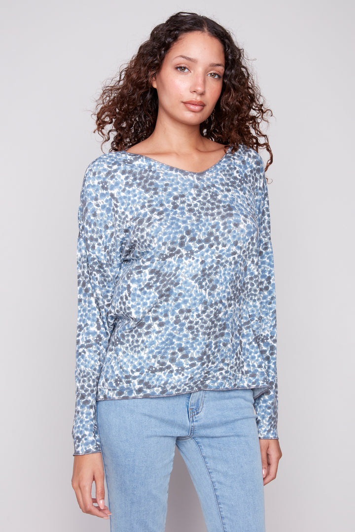 Charlie B Fall 2025 
It features a flattering soft cut v-neck and a neat tie-dye print. Wear it with jeans or capris for an elevated casual look.
