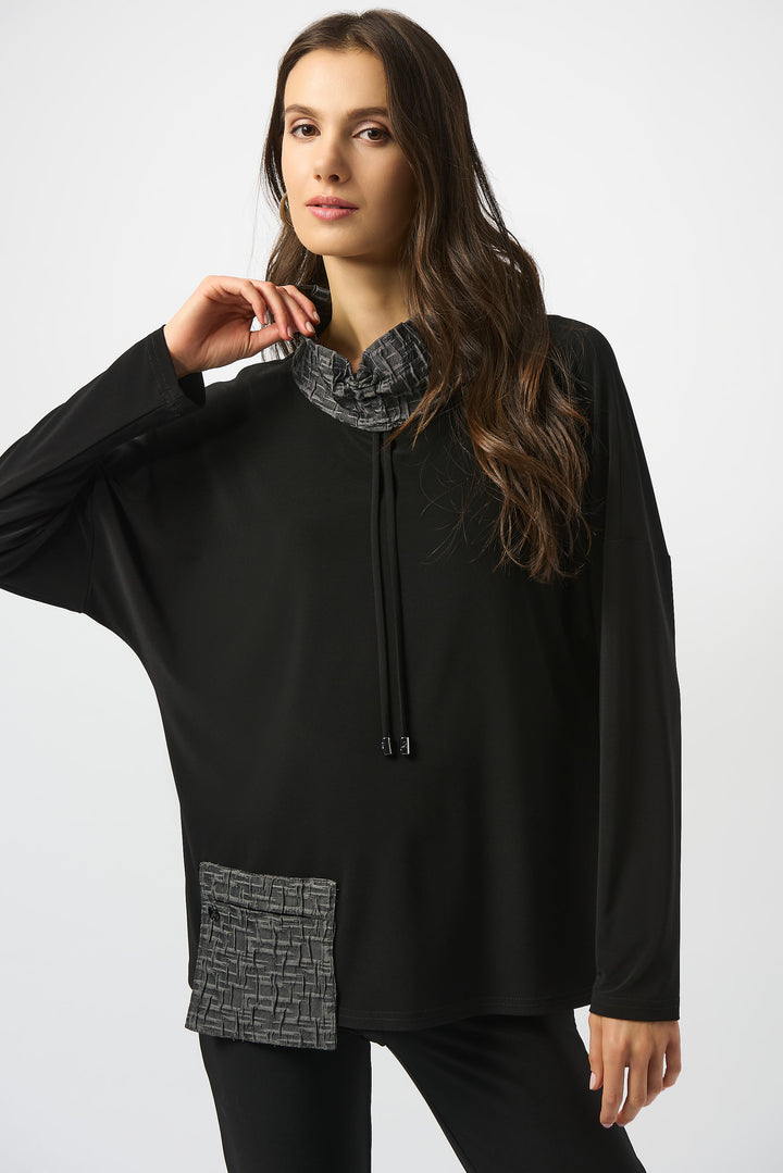 Joseph Ribkoff Fall 2025  Styled with long sleeves, drawstring and a front pocket, it features a snuggly contrast cowl neck for an ultra-cozy feel. 