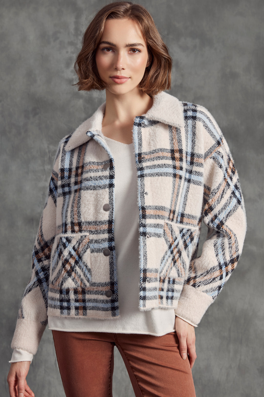 Charlie B Fall 2025 
 Crafted with soft yarn, front buttons, a contrast neckline and cuffs and a plaid design print. Stay cozy with the added patch pockets. 