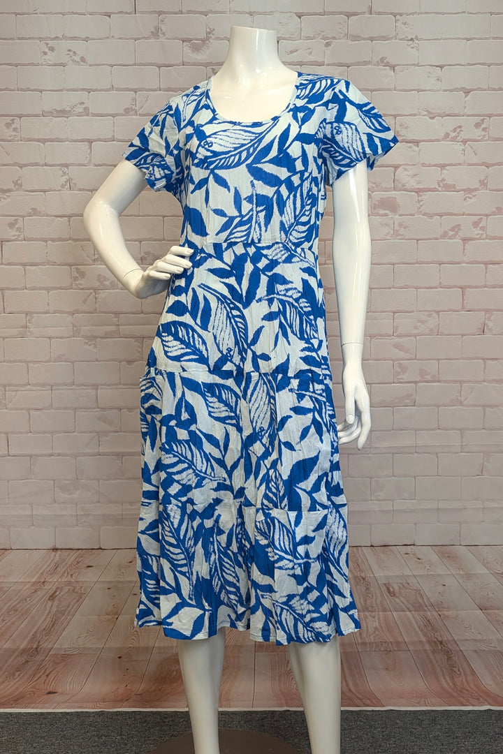 ORIENTIQUE Spring 2025 Stand out with its vibrant blue tropical flare and conveniently store your essentials in the large front pockets. The hem features light crinkle pleats for a unique touch. Perfect for any summer adventure!
