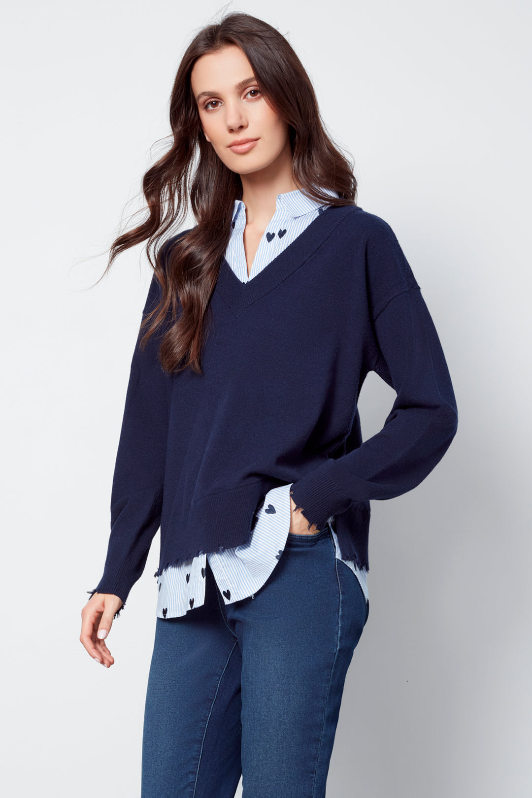 Charlie B Fall 2025 
Discover endless styling possibilities with the Fooler Sweater With Shirt Collar. Its 2-in-1 design effortlessly creates a layered look, while the frayed edge hem adds a touch of edginess.