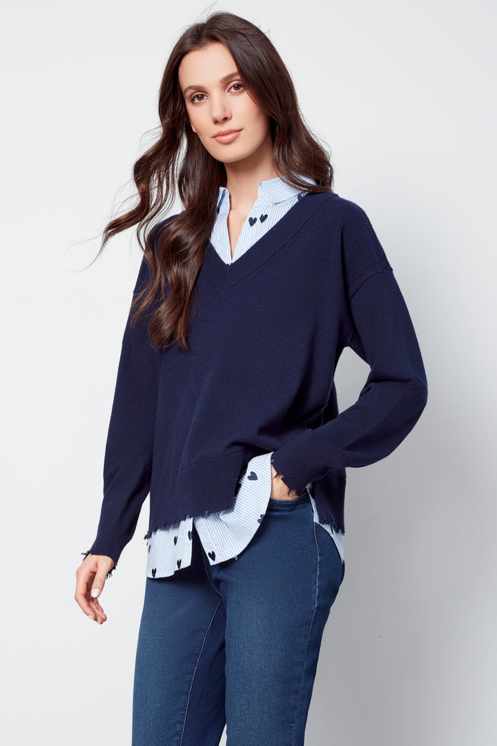 Charlie B Fall 2025 
Discover endless styling possibilities with the Fooler Sweater With Shirt Collar. Its 2-in-1 design effortlessly creates a layered look, while the frayed edge hem adds a touch of edginess.