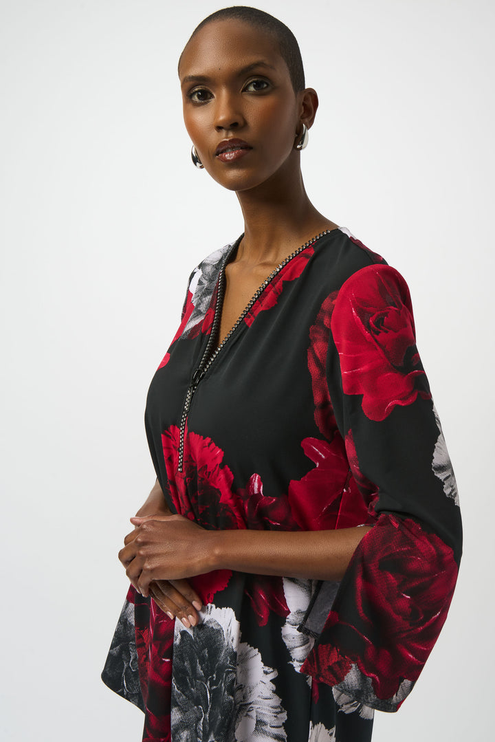 Joseph Ribkoff Fall 2025 Be ready with this stylish Zip Neck Tunic! Featuring stunning 3/4 flare sleeves, a zipped v-neckline and a chic, modern yet classic flowing rose print top, this garment adds a unique touch to any wardrobe.