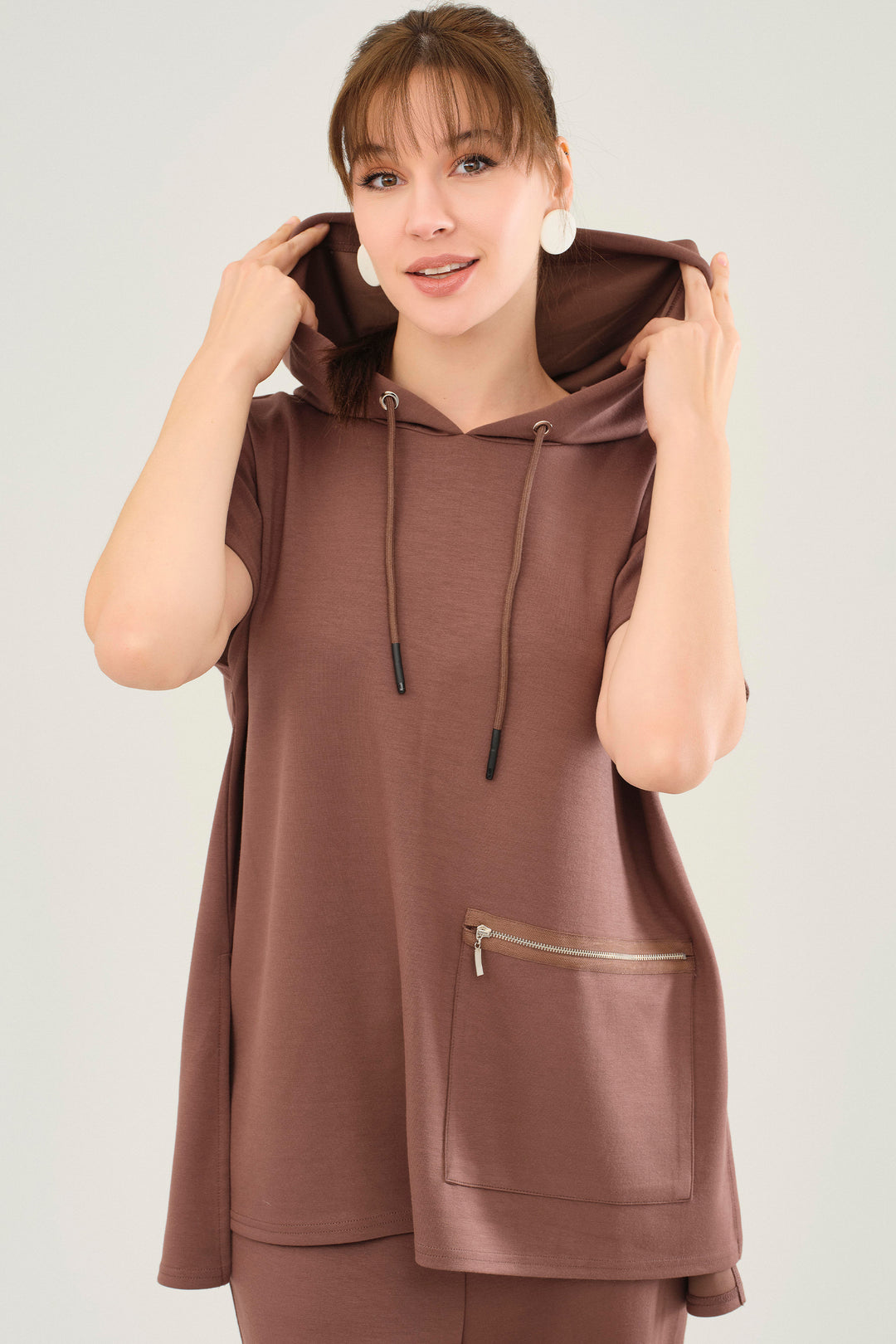 It is beautifully constructed with a luxe sweet chocolate hue (the brown version) and a hooded neckline. A large side pocket adds an extra touch of practicality, while the lower back hem provides a figure-flattering looser fit. 