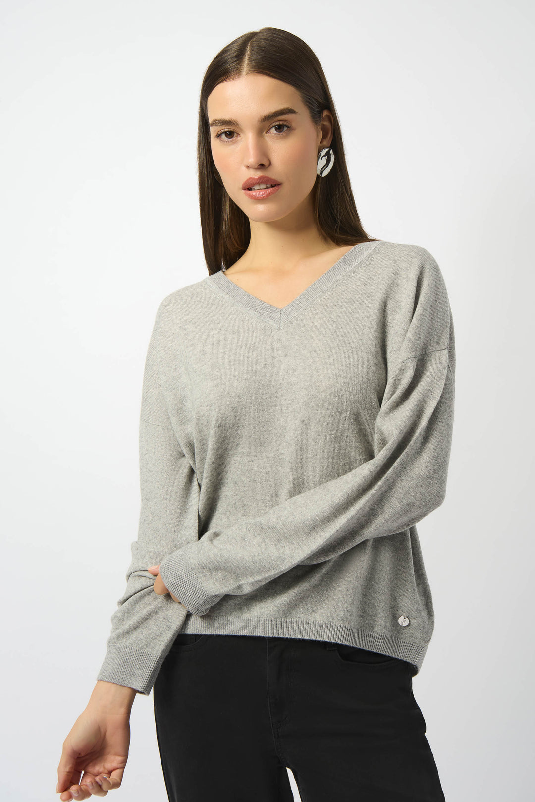Joseph Ribkoff Fall 2025 
This wool knit blend sweater features a contrast ribbed V-neck, cuffs, and hem, offering a refined yet understated look. Its long straight sleeves and simple design make it an ideal choice for both office wear and casual outings. 