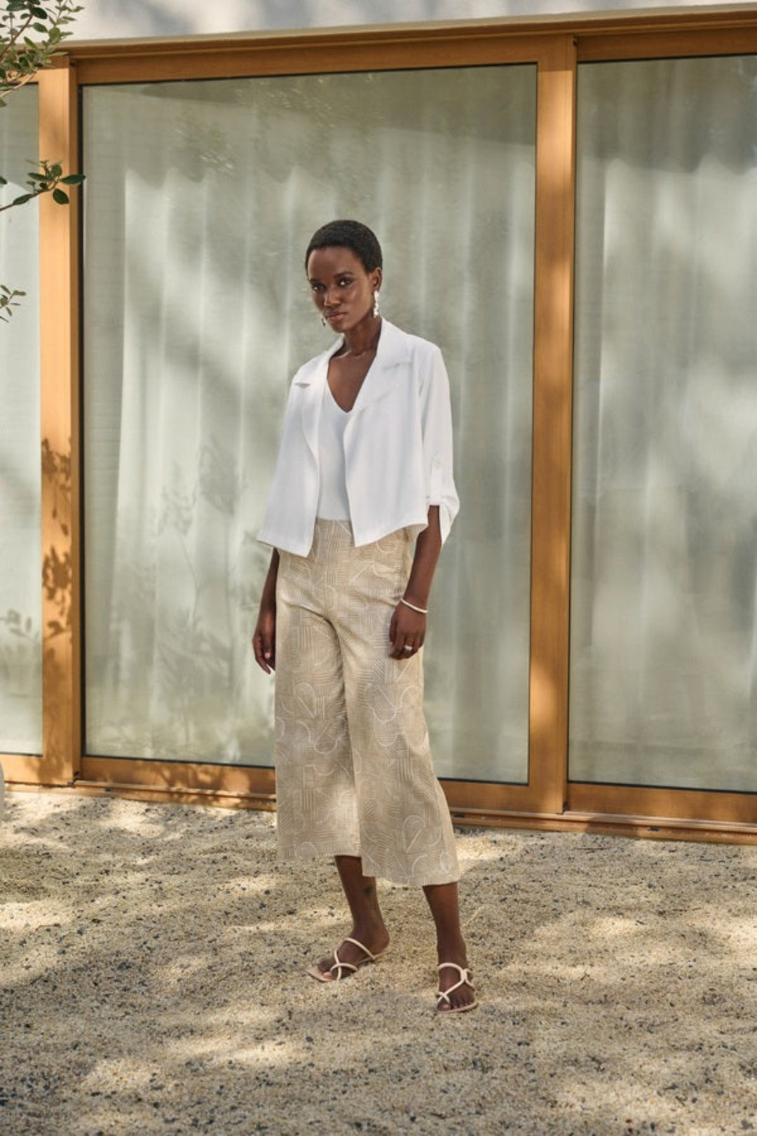 Joseph Ribkoff Summer 2024 Expertly designed with a sleek and simple open front style, the Crop Tab Sleeve Jacket features button tab sleeves and a wide classic collar. 