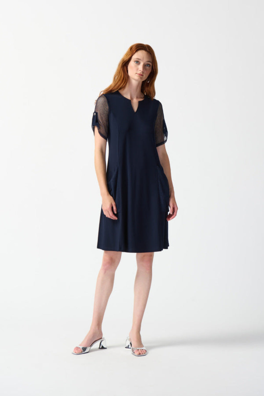 Joseph Ribkoff Summer 2024  The classic A-line silhouette and knee length make it versatile for any occasion, while the sleek mesh fabric on the sleeves adds a touch of sophistication. 